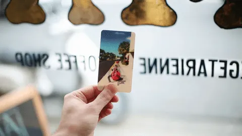 A hand tilting a Pops lenticular photo print to animate a Boomerang